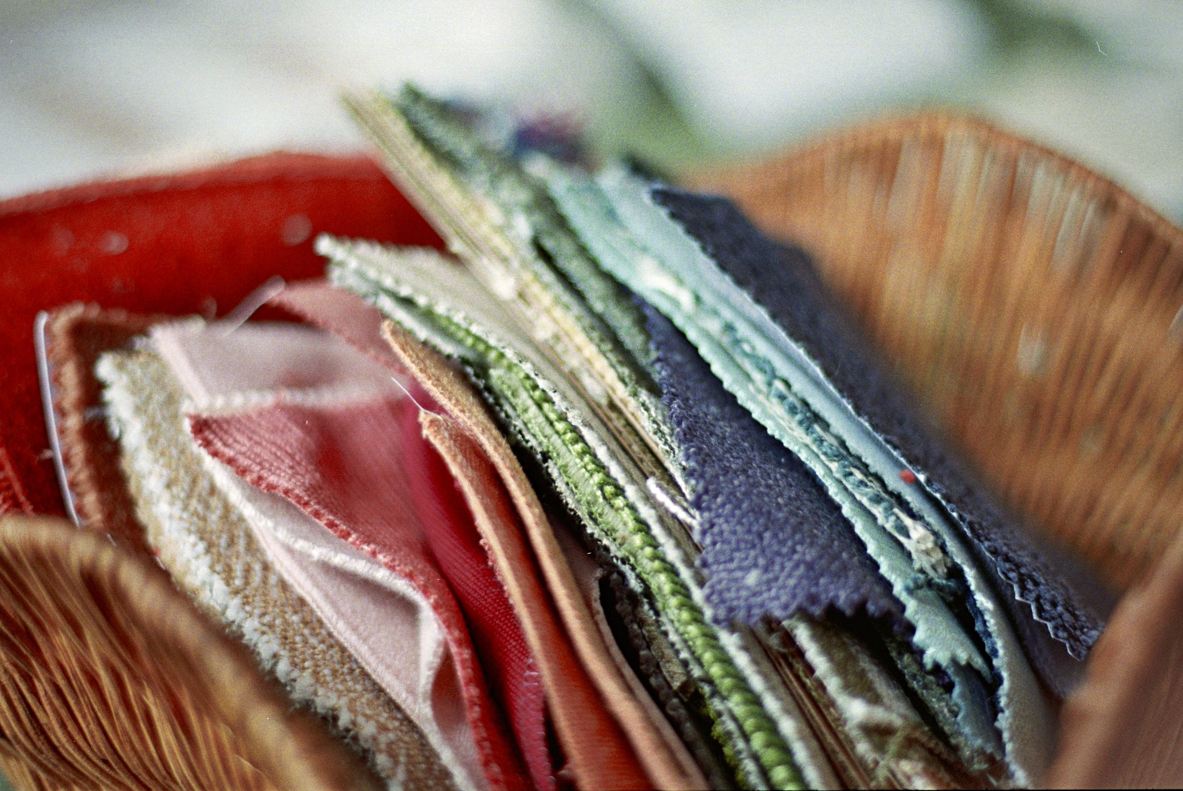 Fabric swatches in wicker basket — interior design materials