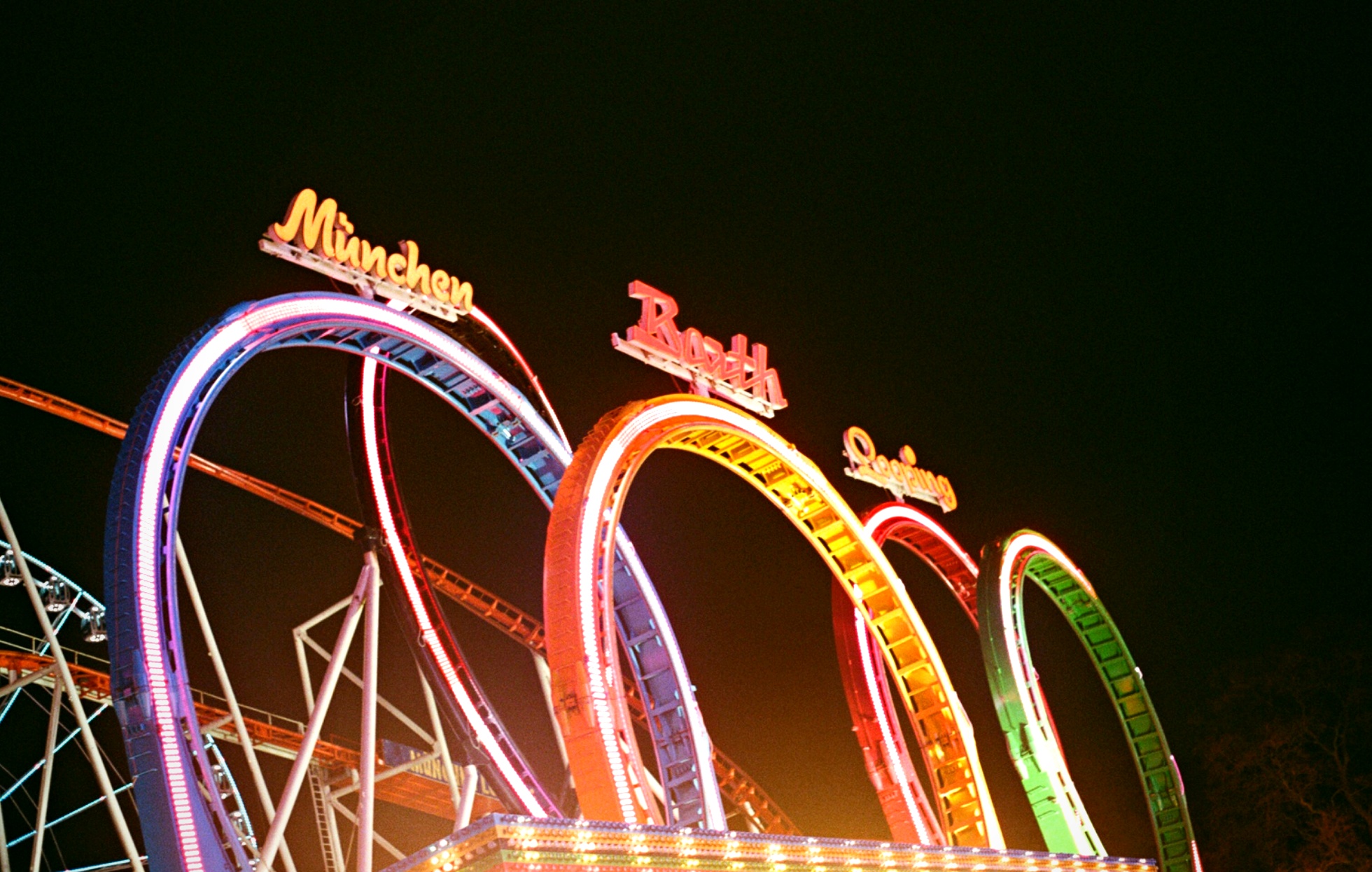 Neon roller coaster Winter Wonderland Hyde Park London — event landscape film photography