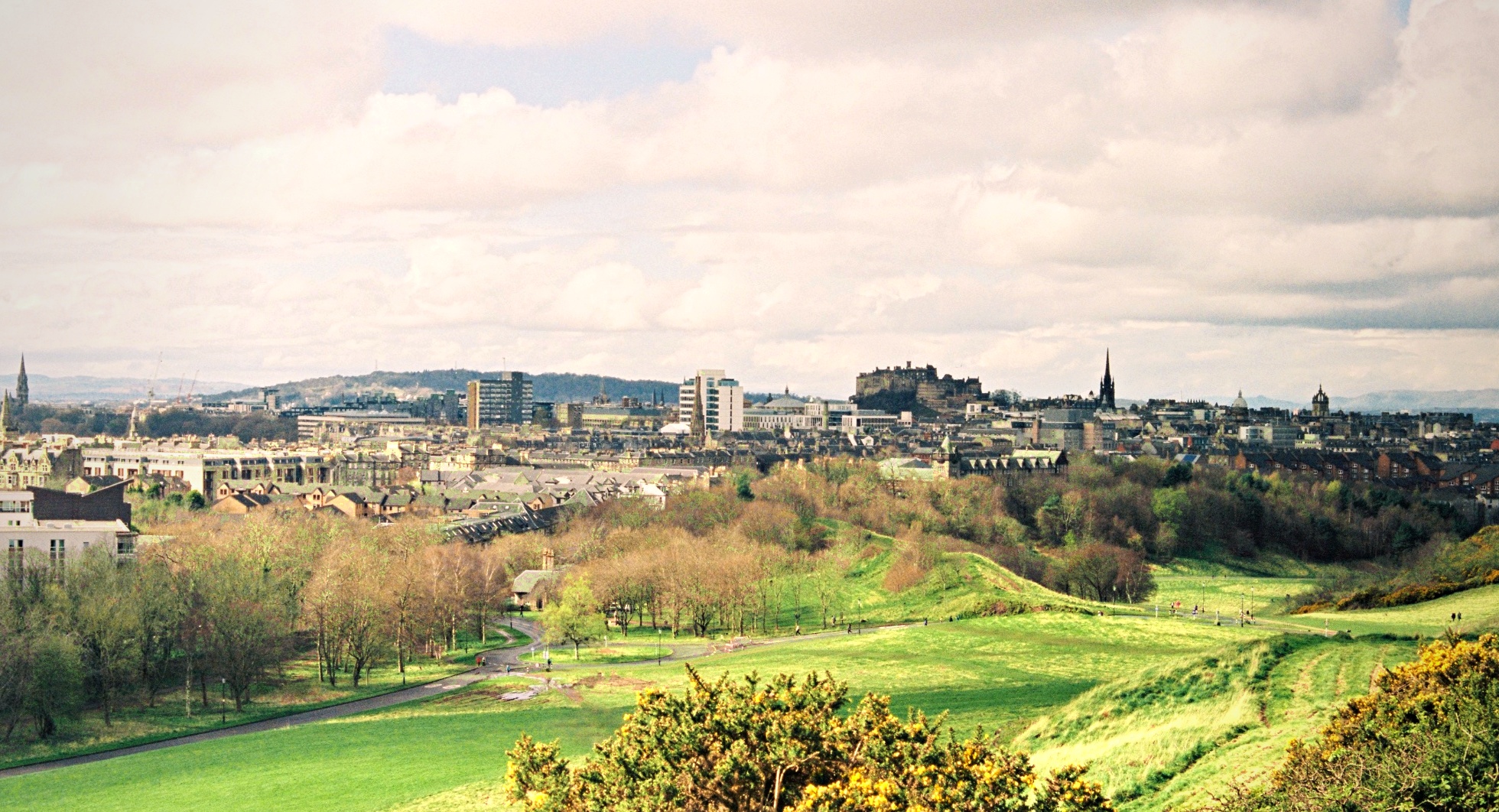 Edinburgh panorama from Arthurs Seat Castle spires green hills Scotland — travel landscape film