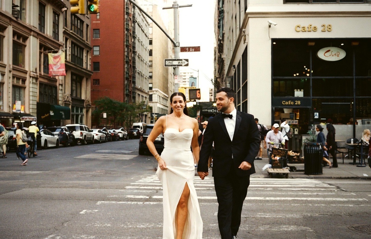 Wedding couple holding hands crossing 5th Avenue New York — film photography