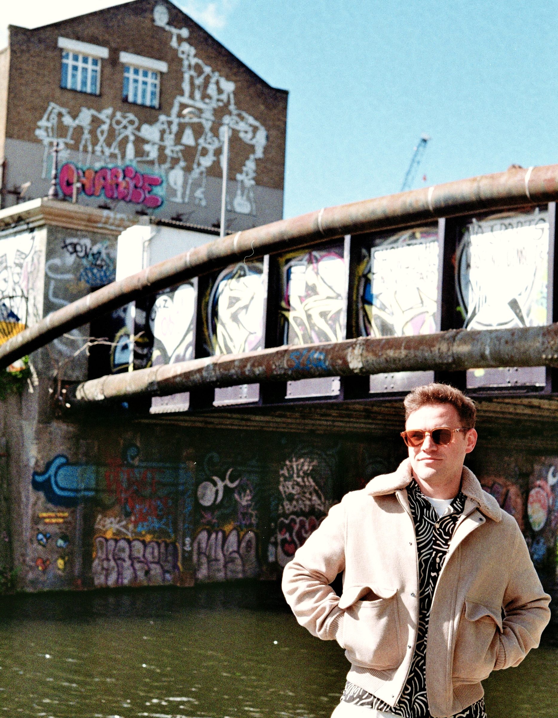 Portrait by Hackney canal graffiti bridge London — urban portrait film photography