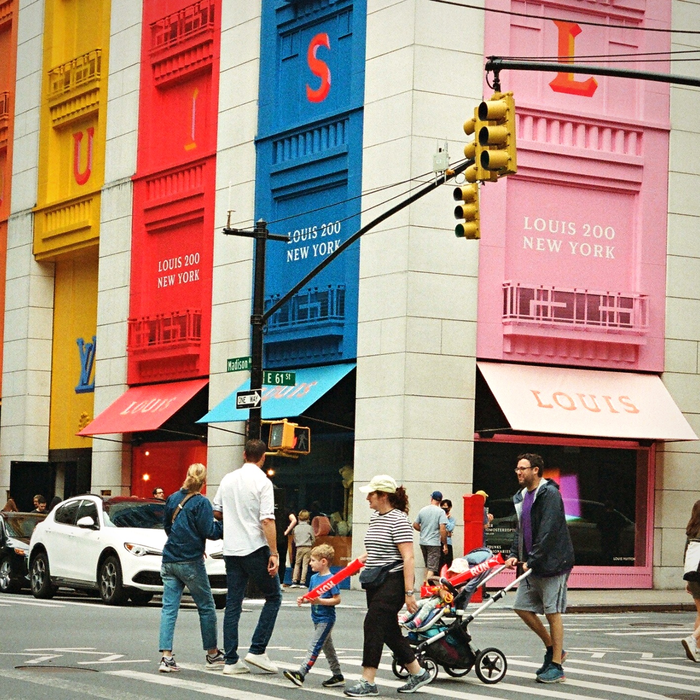 Louis Vuitton 200 colourful facade family crossing Madison Avenue — film photography
